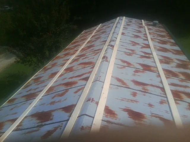 Rusted metal roof panels with new wood purlins before replacement — Storm Damage Roof Repair in Hermitage by Roofing Brothers