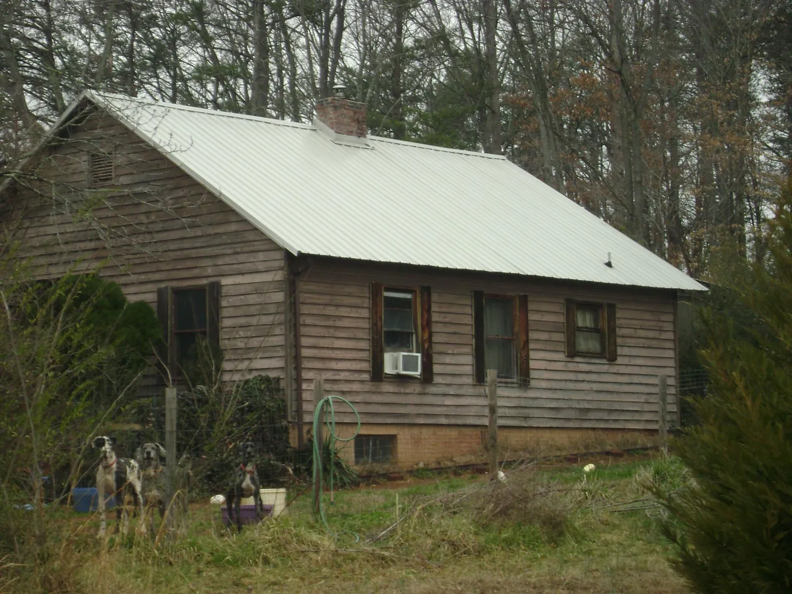 White metal roof on an old wood sided farmhouse, from a Metal Roof Installation job in Hermitage
